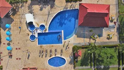 an overhead view of a swimming pool at a resort at In the HEART of Jaco at Villas Paraiso in Jacó