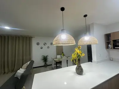 a kitchen and living room with two chandeliers at Apt 3BR,2BA, 4mi from SJO Airport, Pool,Gated, Gym in Alajuela City