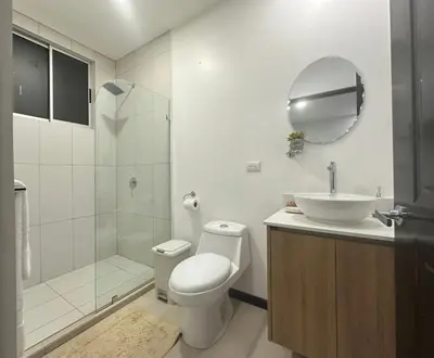 a bathroom with a toilet and a sink and a shower at Apt 3BR,2BA, 4mi from SJO Airport, Pool,Gated, Gym in Alajuela City