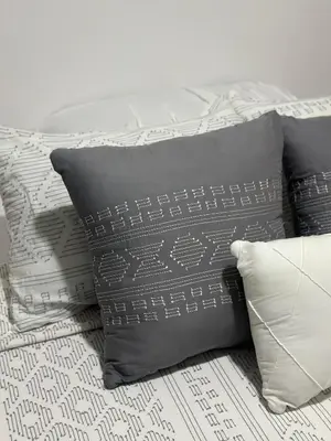 a group of pillows sitting on top of a bed at Apt 3BR,2BA, 4mi from SJO Airport, Pool,Gated, Gym in Alajuela City