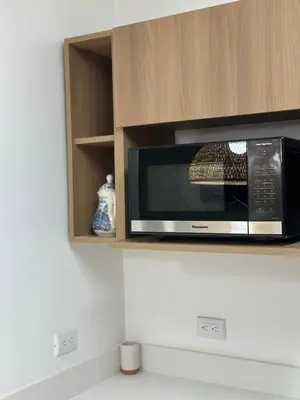 a microwave oven sitting on top of a kitchen counter at Apt 3BR,2BA, 4mi from SJO Airport, Pool,Gated, Gym in Alajuela City