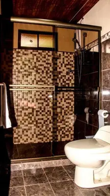 a bathroom with a toilet and a shower at Morada La Gloria in Barbacoas