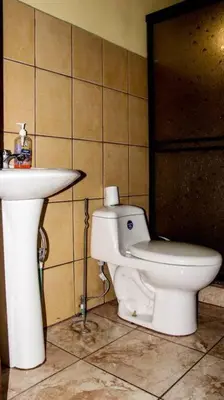 a bathroom with a toilet and a sink at Morada La Gloria in Barbacoas