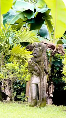 a statue of a bear standing in the grass at Morada La Gloria in Barbacoas