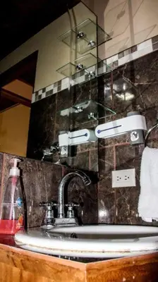a bathroom counter with a sink and a mirror at Morada La Gloria in Barbacoas