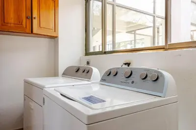 a washing machine in a kitchen with a window at Private Beach Mansion Ocean View at Tambor Hills in Tambor