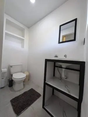a bathroom with a toilet and a mirror on the wall at Villa Jalapa 