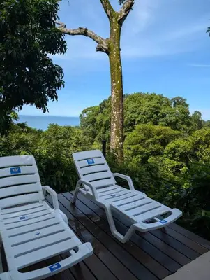 two white chairs sitting on top of a wooden deck at Villa Jalapa 