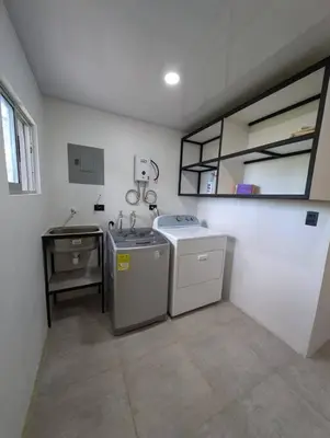 a kitchen with a sink and a washing machine at Villa Jalapa 