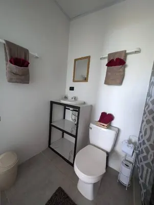 a bathroom with a white toilet and a sink at Villa Jalapa 