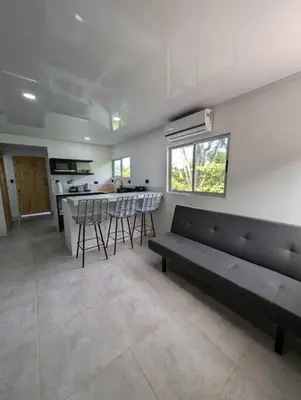 a living room with a couch and a kitchen at Villa Jalapa 