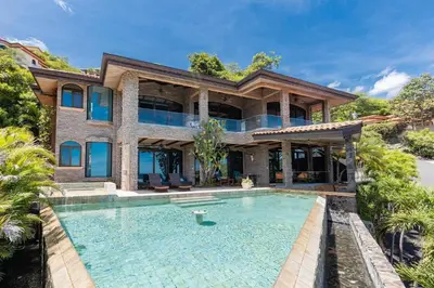 an exterior view of a house with a swimming pool at Casa De Los Sueos in Playa Hermosa