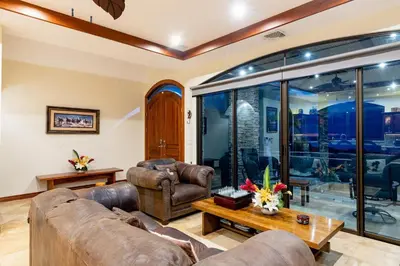 a living room with a couch and a table at Casa De Los Sueos in Playa Hermosa