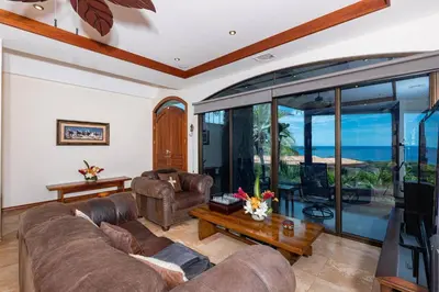 a living room with a couch and a table at Casa De Los Sueos in Playa Hermosa