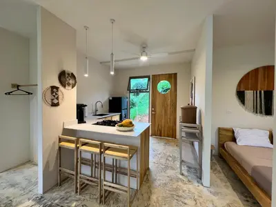a kitchen and living room with a kitchen island in a room at Alta Loma in Ojochal