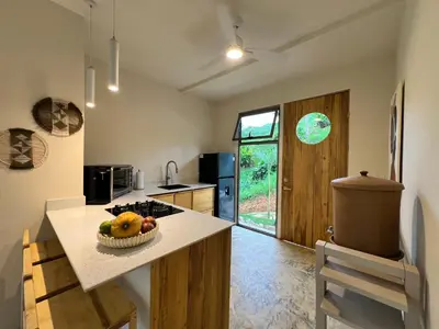 a kitchen with a counter with a bowl of fruit on it at Alta Loma in Ojochal
