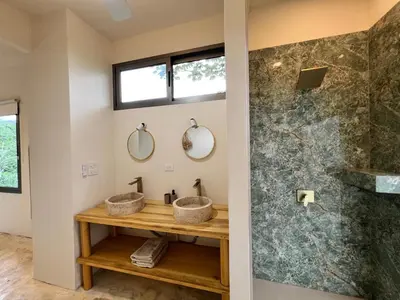 two sinks in a bathroom with two mirrors at Alta Loma in Ojochal