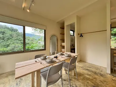 a dining room with a wooden table and chairs at Alta Loma in Ojochal
