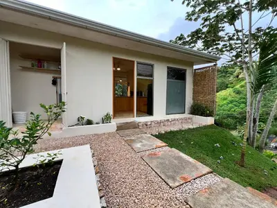a small white house with a walkway in front of it at Alta Loma in Ojochal
