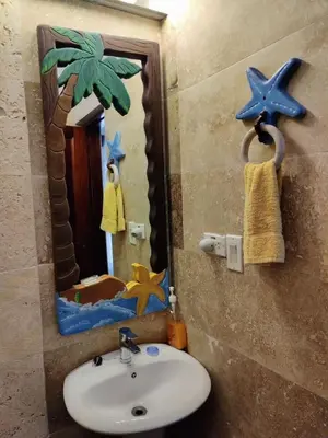 a bathroom with a sink and a mirror at Tico Tiki Vacation Villa, 5 Bedroom in Sámara