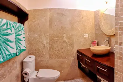 a bathroom with a toilet and a sink at Tico Tiki Vacation Villa, 3 Bedroom in Sámara