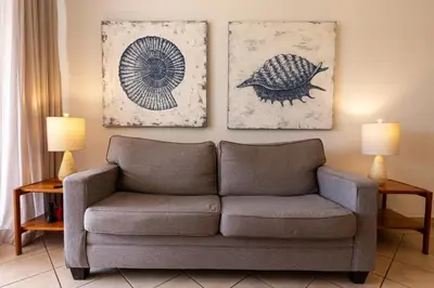 a living room with a couch and two pictures on the wall at Sunrise 42 - 2 Bedroom Ocean View Condo in Tamarindo