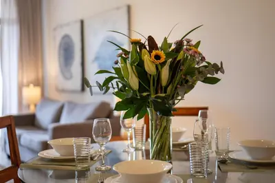 a table with a vase of flowers on it at Sunrise 42 - 2 Bedroom Ocean View Condo in Tamarindo