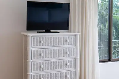 a tv sitting on top of a white dresser at Sunrise 42 - 2 Bedroom Ocean View Condo in Tamarindo