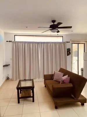 a living room with a couch and a ceiling fan at A6 PL Near the Beach 1bed 1bath private terrace in Tamarindo