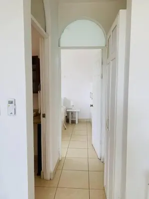 a hallway with an archway and a room with white doors at A6 PL Near the Beach 1bed 1bath private terrace in Tamarindo