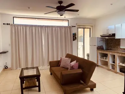 a living room with a couch and a ceiling fan at A6 PL Near the Beach 1bed 1bath private terrace in Tamarindo