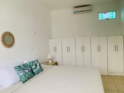 a bedroom with a large bed with white cabinets at A6 PL Near the Beach 1bed 1bath private terrace in Tamarindo