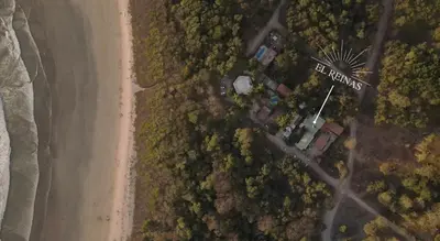 an overhead view of a beach and a windmill at El Reinas by Sugar's Monkey in Playa Grande