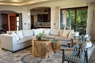 a living room with a white couch and a table at Las Ventanas del Mar-Ridge Condo #13 in Santo Domingo