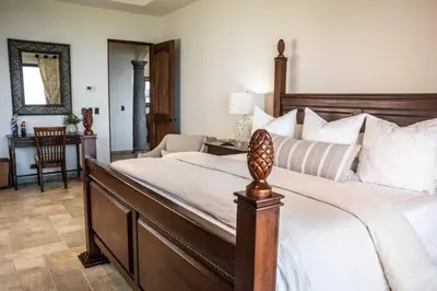 a bedroom with a large bed and a desk at Las Ventanas del Mar-Ridge Condo #13 in Santo Domingo
