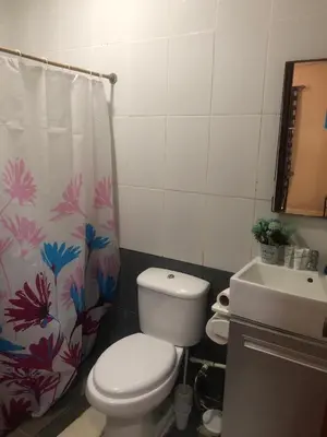 a bathroom with a toilet and a sink and a shower curtain at Tucan in Coco