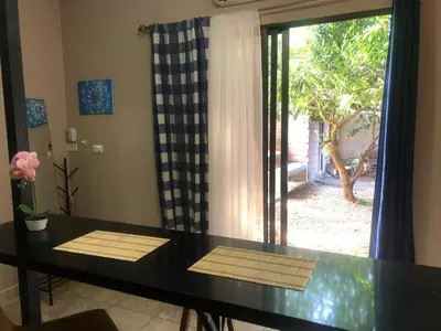 a dining room with a table and a sliding glass door at Tucan in Coco