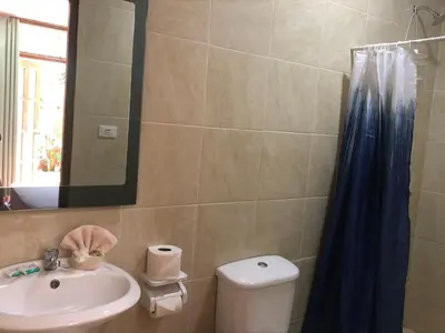 a bathroom with a sink and a toilet and a mirror at Tucan in Coco