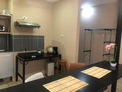 a kitchen with a counter and a sink and a table at Tucan in Coco