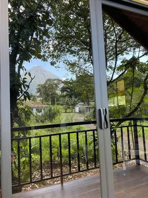 a sliding glass door with a view of a mountain at Cabaña Rincón Verde - La Fortuna in Fortuna