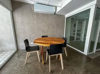 a wooden table and chairs in a room at Ocean Front, Luxurious Condo in Downtown Jaco! in Jacó