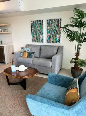 a living room with a couch and a table at Ocean Front, Luxurious Condo in Downtown Jaco! in Jacó