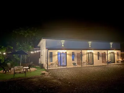 a small white house at night with lights at Cameva Villas - Your perfect escape in Guatemala