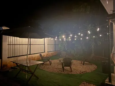a patio with a table and an umbrella and lights at Cameva Villas - Your perfect escape in Guatemala