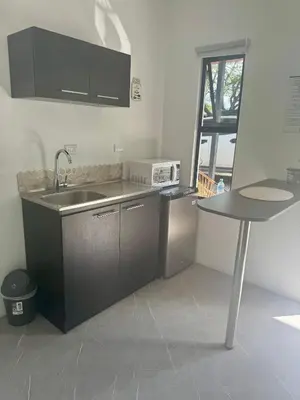 a kitchen with a sink and a table in it at Cameva Villas - Your perfect escape in Guatemala