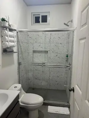 a bathroom with a shower with a toilet and a sink at Cameva Villas - Your perfect escape in Guatemala