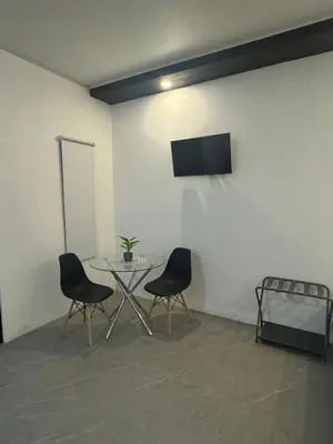 a room with a table and two chairs and a tv at Cameva Villas - Your perfect escape in Guatemala