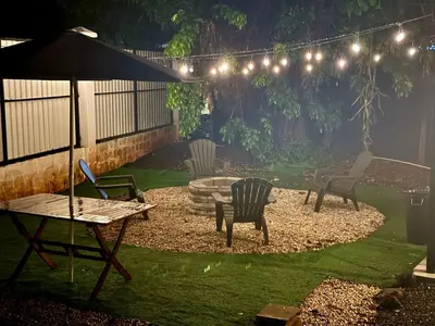 a patio with chairs and a table and an umbrella at Cameva Villas Your perfect escape in Guatemala