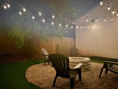 a patio with two chairs and a fire pit with lights at Cameva Villas Your perfect escape in Guatemala