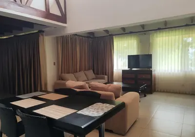 a living room with a couch and a table at Marenaz Oceanfront Resort in Esterillos Este